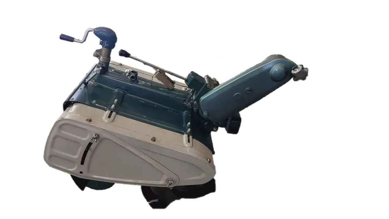 A complete rotary tiller attachment assembly photographed on a plain background, showing its gearbox housing, the belt-drive arm and the blade rotor below the guard